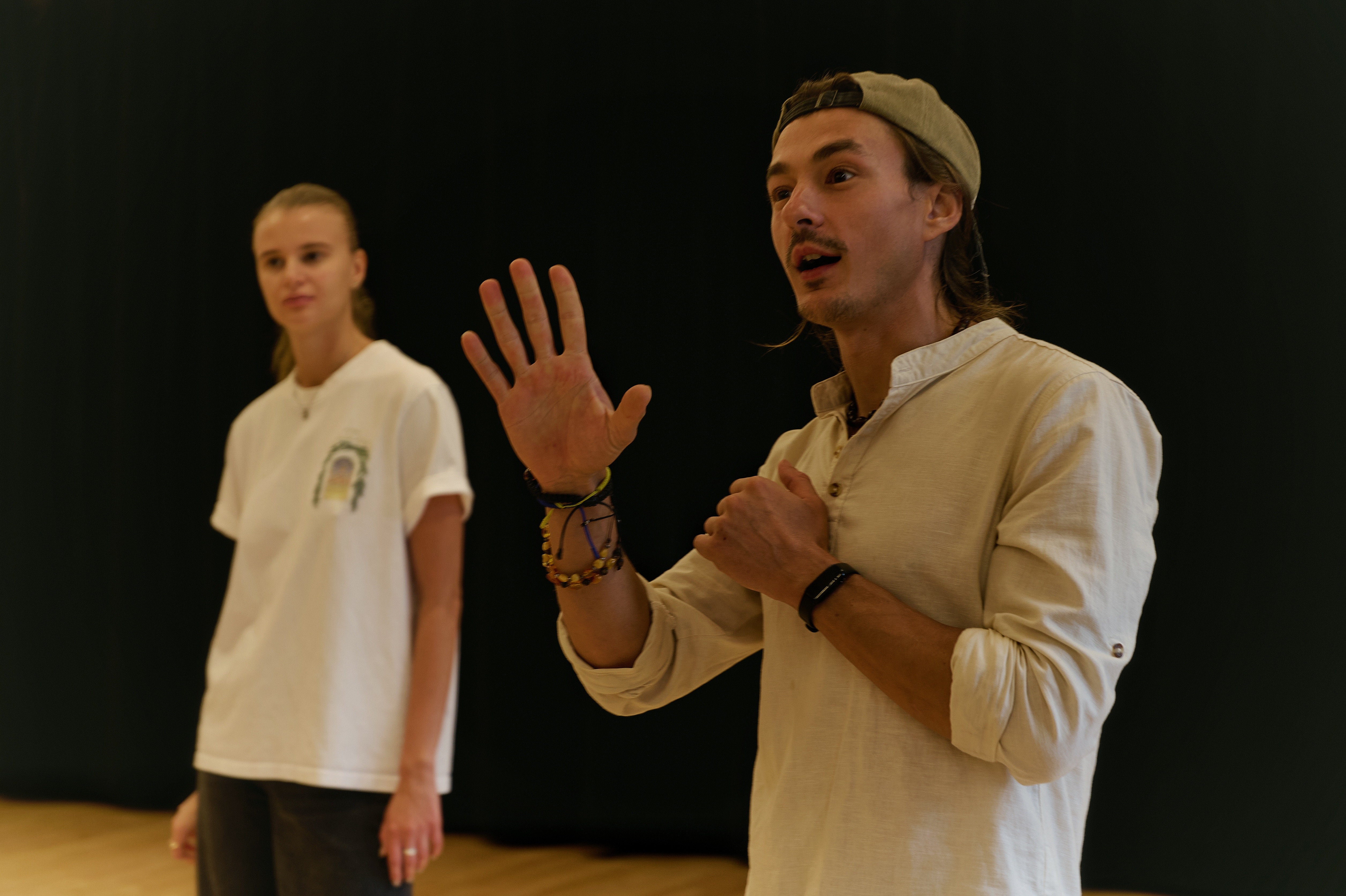 Workshop facilitator providing dynamic instruction with expressive gestures