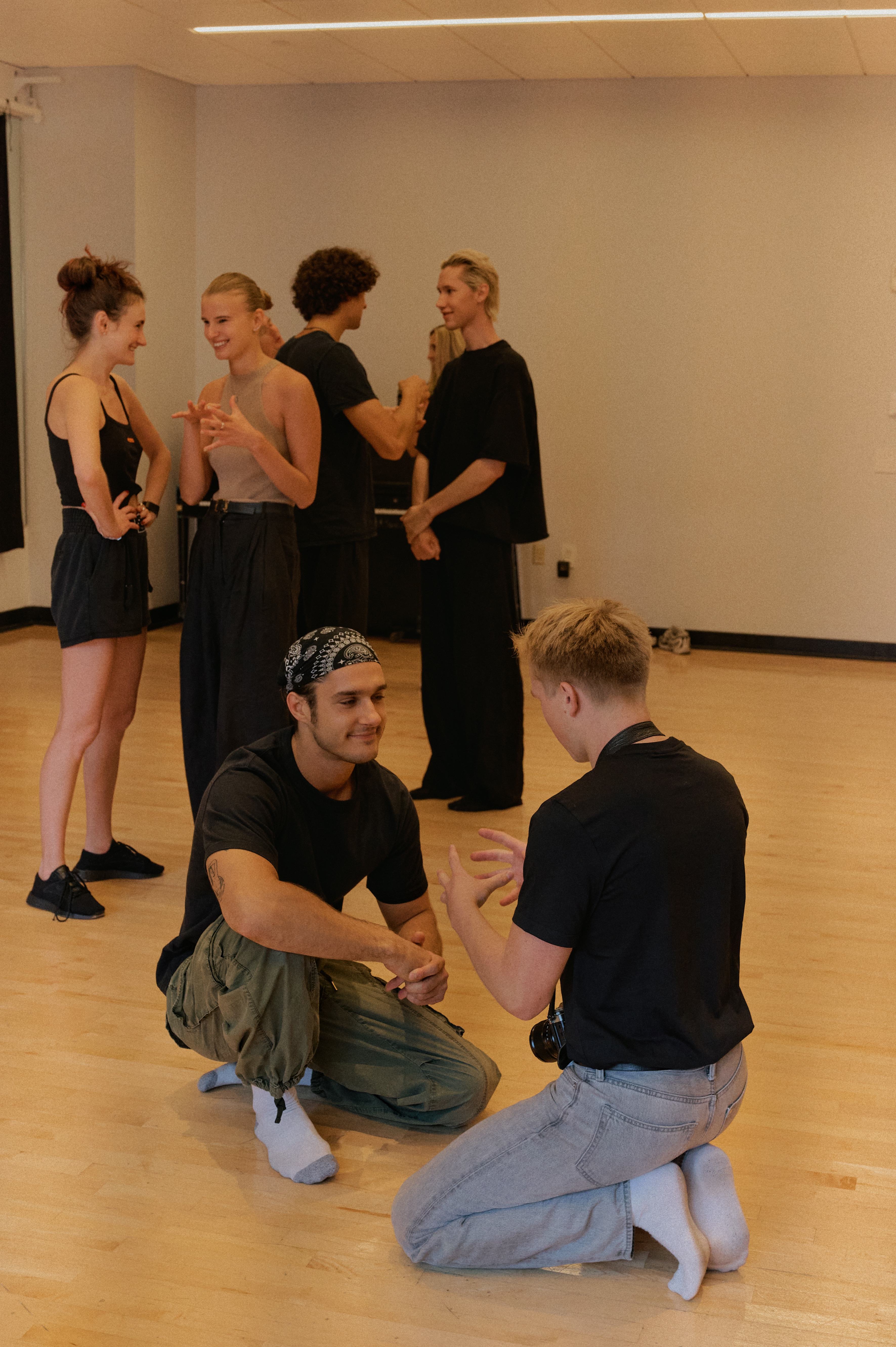 Participants in workshop setting with floor exercises and partner work